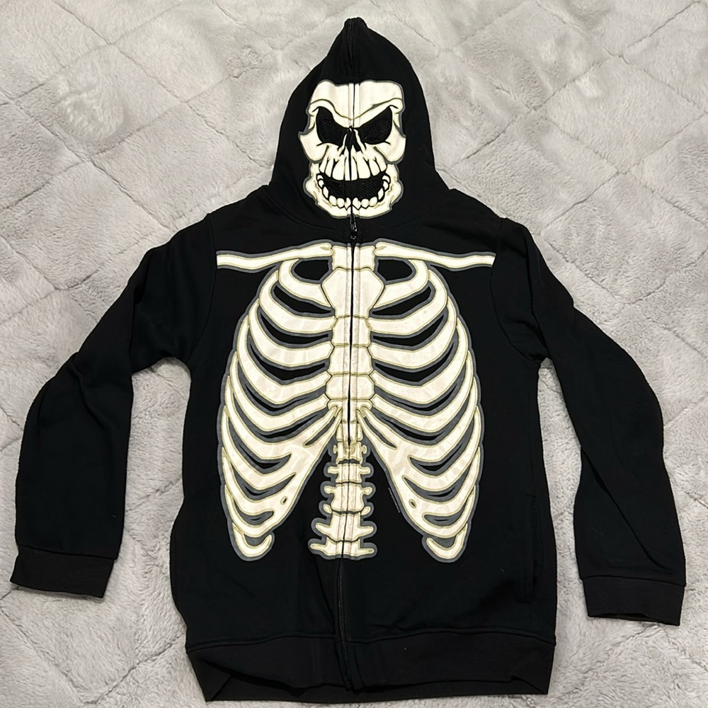 Boy’s XL glow-in-the-dark skeleton hoodie. Hood zips all the way closed.